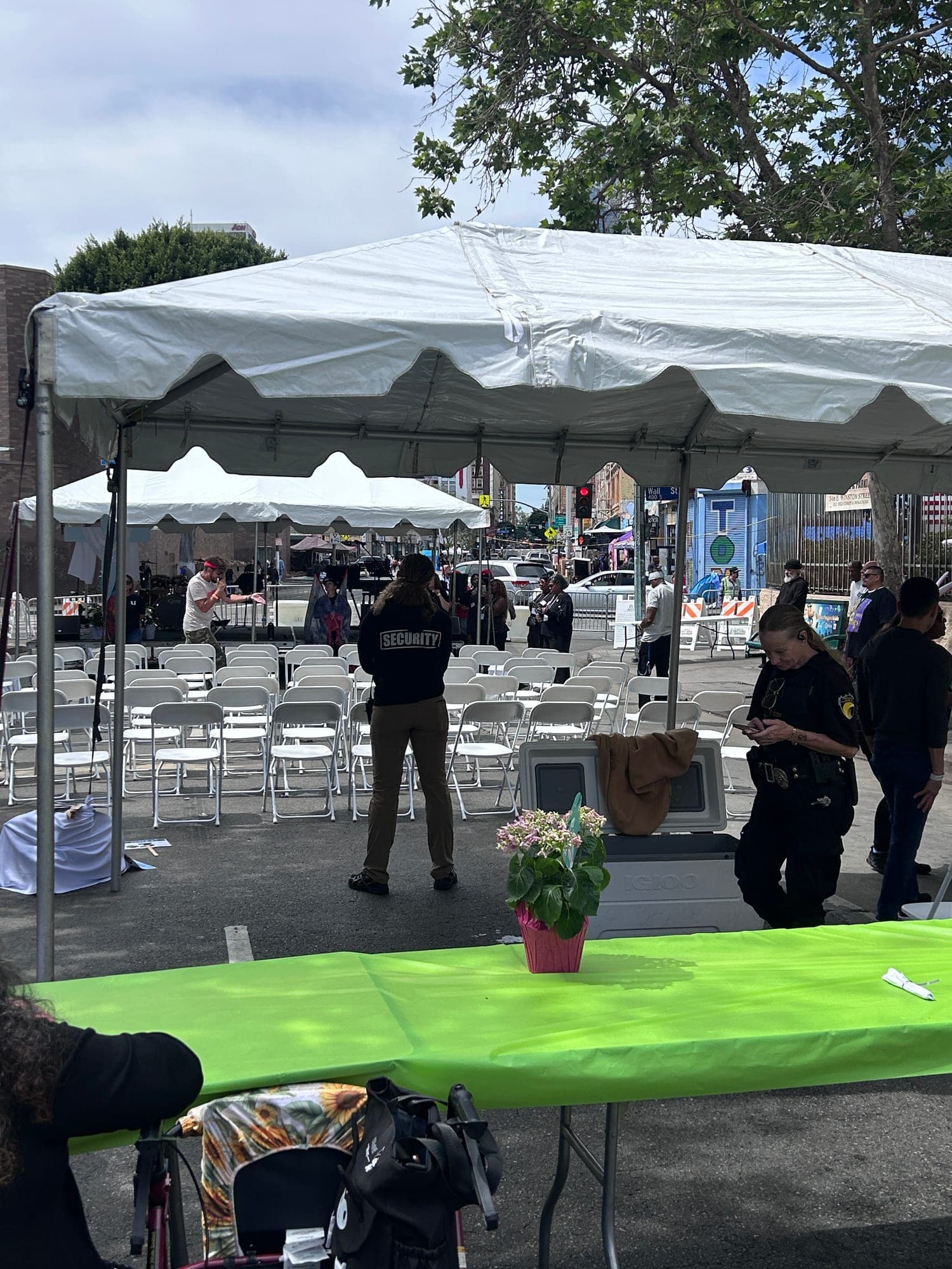 The tented dining area at the Los Angeles Mission with tables laid out and PSLA Worldwide officers positioned around the seating