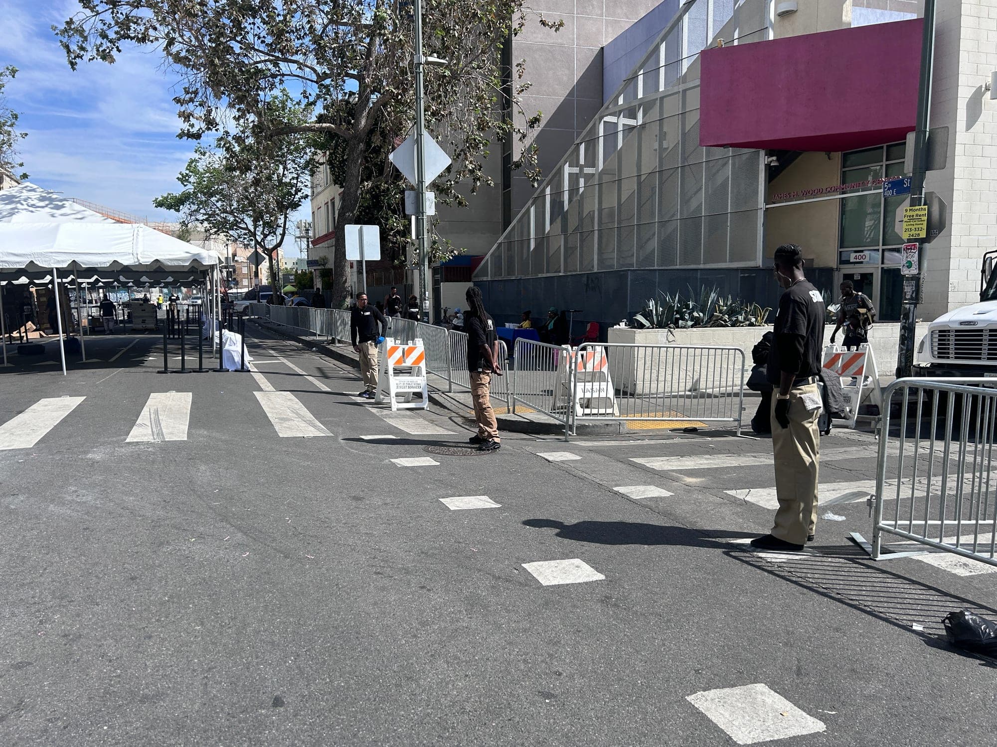 A PSLA Worldwide officer walking the barricade line along a closed downtown street at the Los Angeles Mission event
